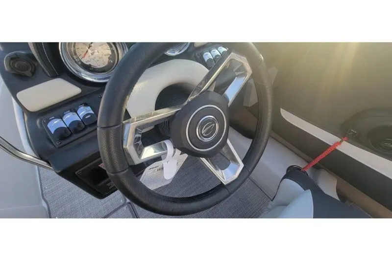 Slide: The Image of Steering wheel of 2024 Crownline 210 SS boat with dashboard controls. - 20