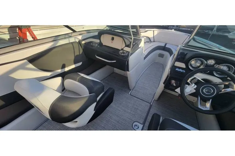 Slide: The Image of 2024 Crownline 210 SS boat interior with modern dashboard and seating. - 21