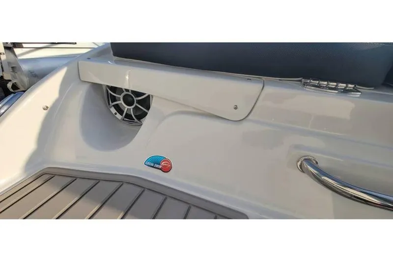 Slide: The Image of 2024 Crownline 210 SS boat interior with speaker and stainless steel handle. - 7