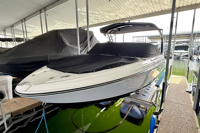 Slide: The Image of 2019 Chaparral Vortex 223 VRX boat docked with cover in marina. - 18
