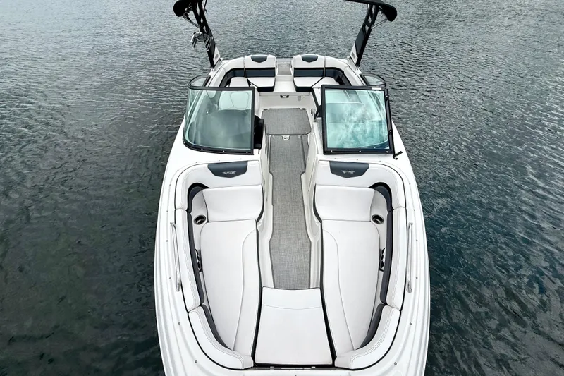Slide: The Image of 2019 Chaparral Vortex 223 VRX boat on water, featuring sleek interior design. - 22