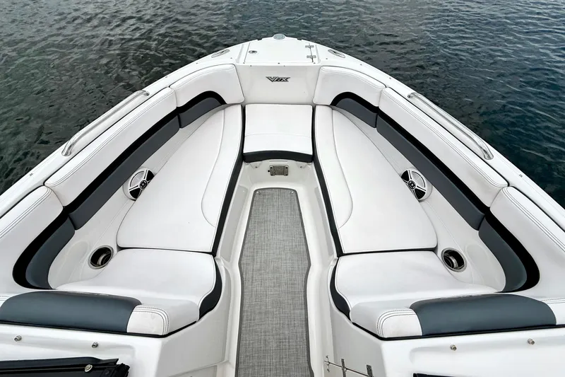Slide: The Image of 2019 Chaparral Vortex 223 VRX boat interior with white seating and water view. - 23