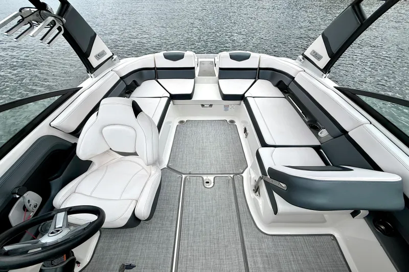 Slide: The Image of 2019 Chaparral Vortex 223 VRX boat interior with sleek seating and modern design on water. - 24