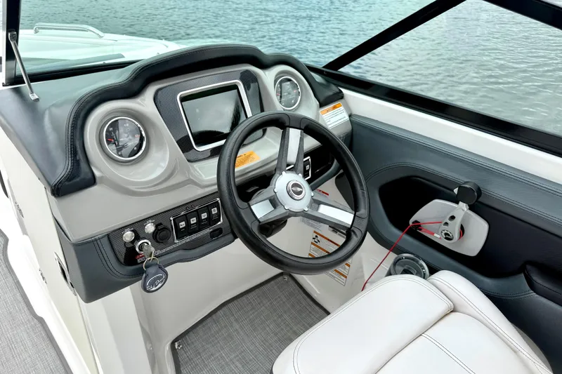 Slide: The Image of 2019 Chaparral Vortex 223 VRX boat dashboard with steering wheel and controls. - 27