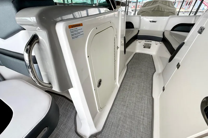 Slide: The Image of 2019 Chaparral Vortex 223 VRX interior with seating and storage compartment. - 29