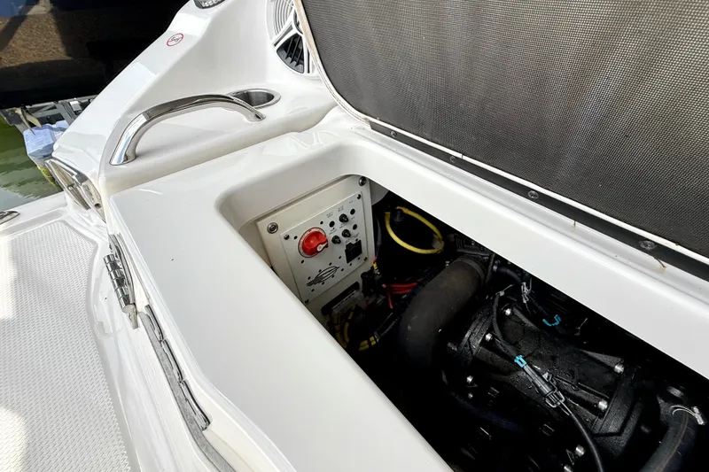 Slide: The Image of Engine compartment of a 2019 Chaparral Vortex 223 VRX boat, showcasing control panel and components. - 35