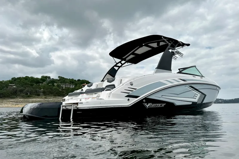 Slide: The Image of 2019 Chaparral Vortex 223 VRX boat on calm water under cloudy sky. - 4