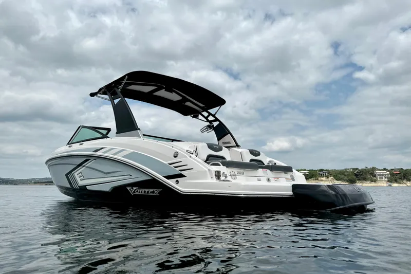 Slide: The Image of 2019 Chaparral Vortex 223 VRX boat on calm water under cloudy sky. - 6