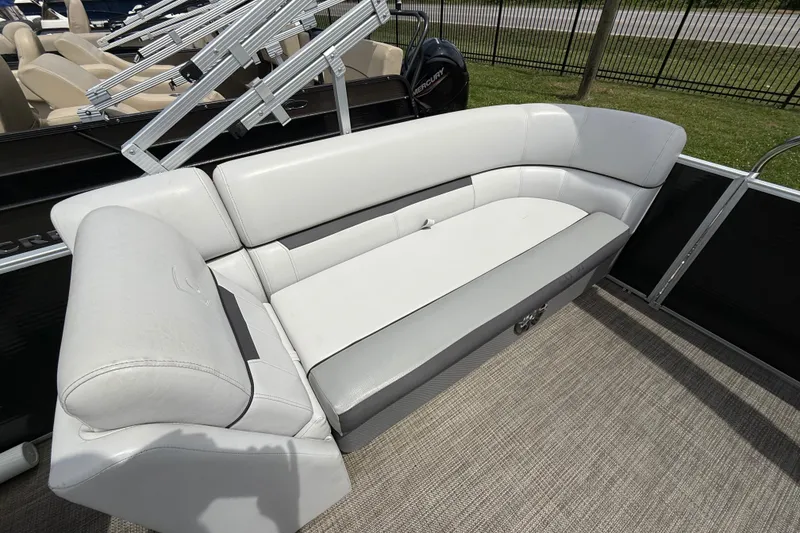 Slide: The Image of 2022 Godfrey Sweetwater 2286 SB boat interior with white seating and carpeted floor. - 11