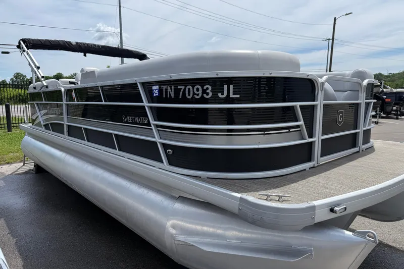 Slide: The Image of 2022 Godfrey Sweetwater 2286 SB pontoon boat parked on pavement. - 2