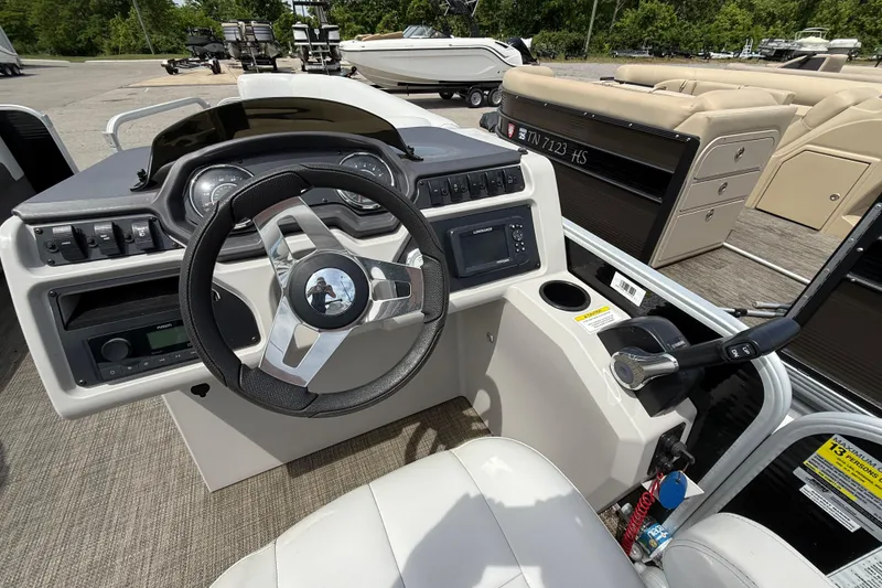 Slide: The Image of 2022 Godfrey Sweetwater 2286 SB boat dashboard with steering wheel and controls. - 8