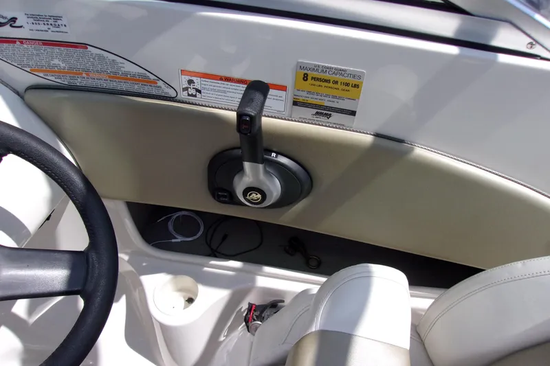 Slide: The Image of 2007 Sea Ray 185 Sport boat interior with steering wheel and throttle controls. - 8
