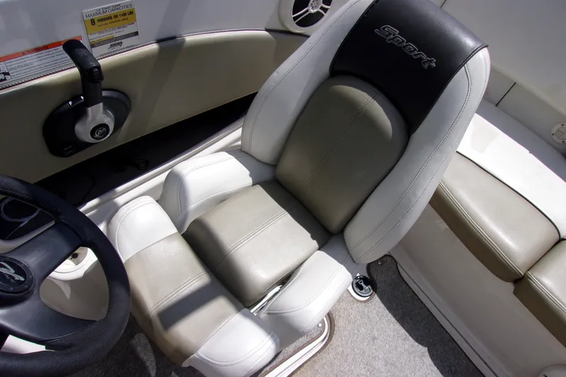 Slide: The Image of Captain's seat of a 2007 Sea Ray 185 Sport boat, featuring sporty design and controls. - 9