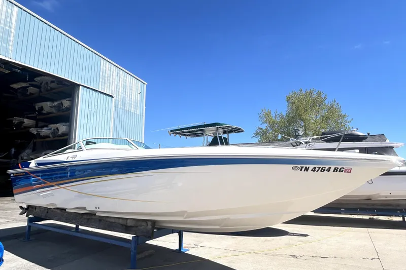 The Image of 2007 Sunsation 32 Dominator boat on trailer, blue and white design, sunny day. - 0
