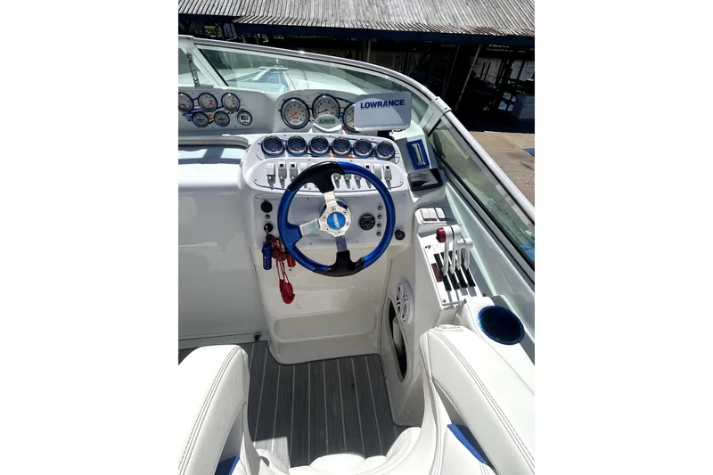 Slide: The Image of 2007 Sunsation 32 Dominator boat cockpit with steering wheel and control panel. - 10
