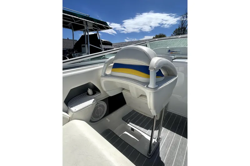 Slide: The Image of 2007 Sunsation 32 Dominator boat interior with white and blue seating under a clear sky. - 13