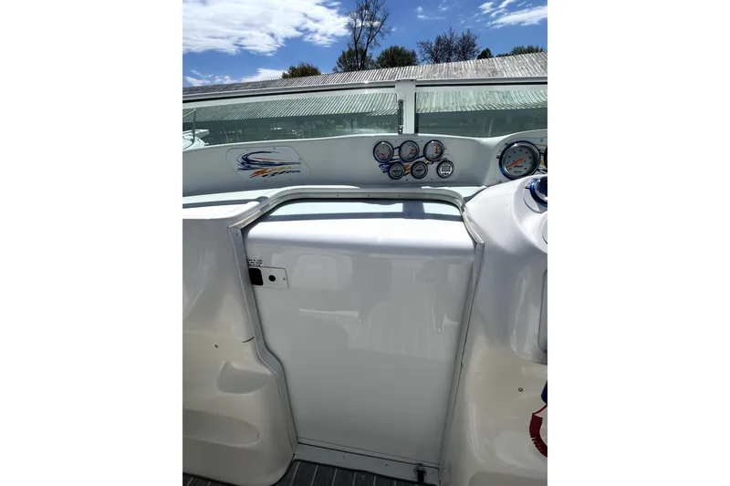 Slide: The Image of 2007 Sunsation 32 Dominator boat dashboard with gauges under a clear sky. - 15