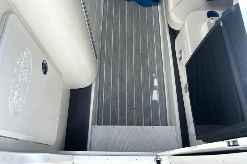 Slide: The Image of Interior view of a 2007 Sunsation 32 Dominator boat, featuring sleek flooring and seating. - 16