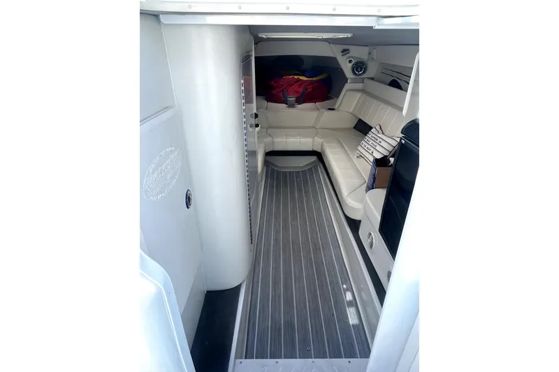 Slide: The Image of Interior of 2007 Sunsation 32 Dominator boat with white seating and wood-style flooring. - 17