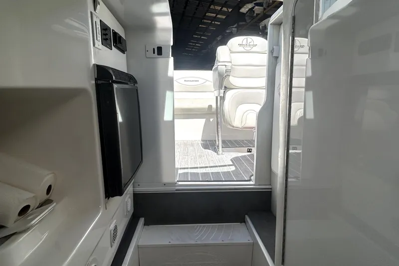 Slide: The Image of Interior view of 2007 Sunsation 32 Dominator boat, featuring seating and compact amenities. - 18