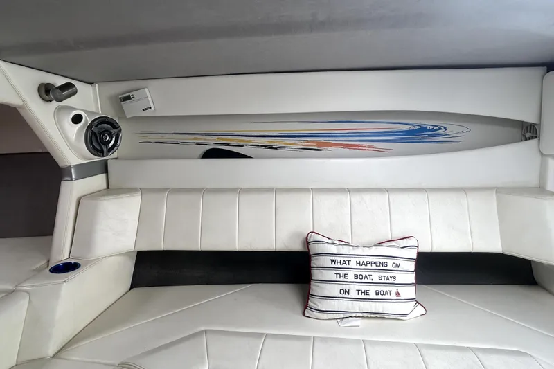 Slide: The Image of Interior of 2007 Sunsation 32 Dominator boat with white seating and decorative pillow. - 19