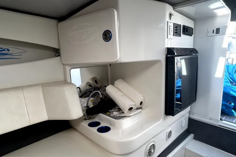 Slide: The Image of Interior of a 2007 Sunsation 32 Dominator boat with kitchenette and storage area. - 23