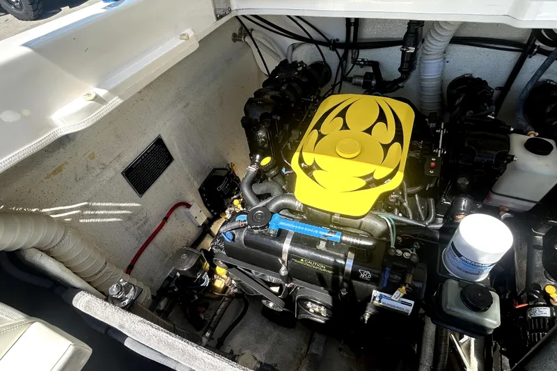 Slide: The Image of Engine compartment of a 2007 Sunsation 32 Dominator boat, featuring a vibrant yellow engine cover. - 25