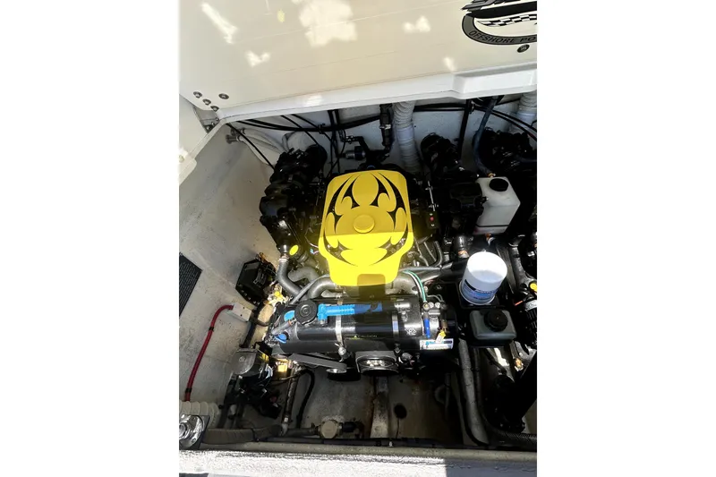 Slide: The Image of Engine compartment of a 2007 Sunsation 32 Dominator boat with a yellow engine cover. - 27