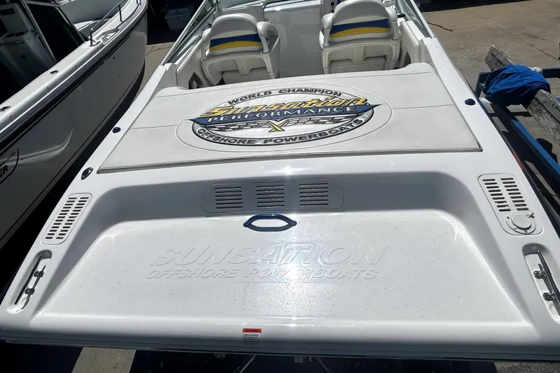 Slide: The Image of 2007 Sunsation 32 Dominator powerboat with logo, white deck, and cushioned seats. - 5