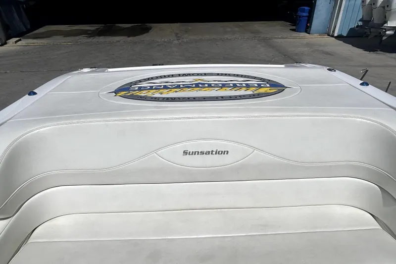 Slide: The Image of 2007 Sunsation 32 Dominator boat with white upholstery and logo on deck. - 7