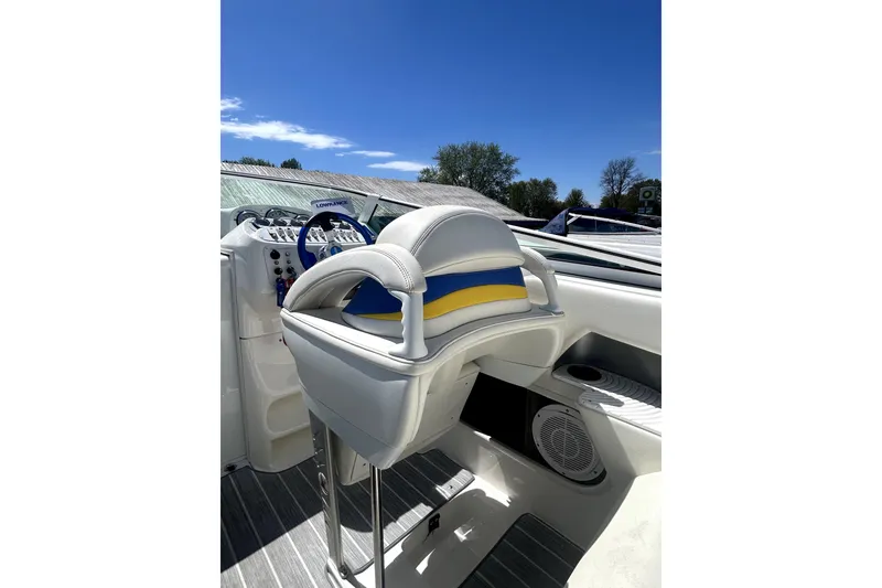 Slide: The Image of 2007 Sunsation 32 Dominator boat interior with steering wheel and seating under clear blue sky. - 9