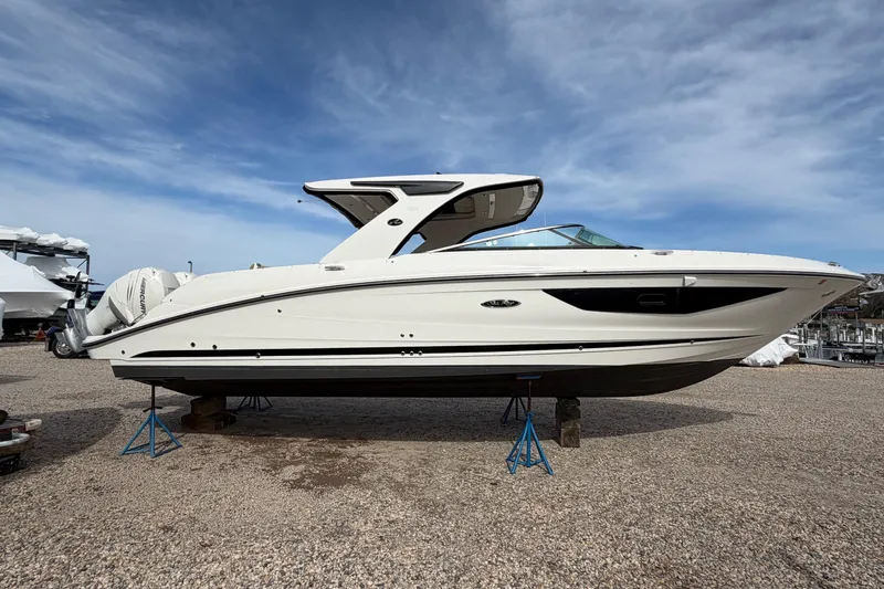 The Image of 2023 Sea Ray SLX 350 Outboard boat on stands, displayed outdoors. - 0