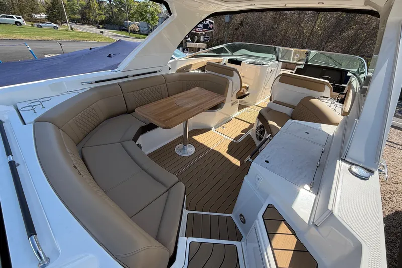 Slide: The Image of Luxurious 2023 Sea Ray SLX 350 Outboard boat interior with elegant seating and wooden table. - 11