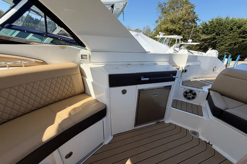 Slide: The Image of Luxurious interior of 2023 Sea Ray SLX 350 Outboard with seating and kitchenette. - 13