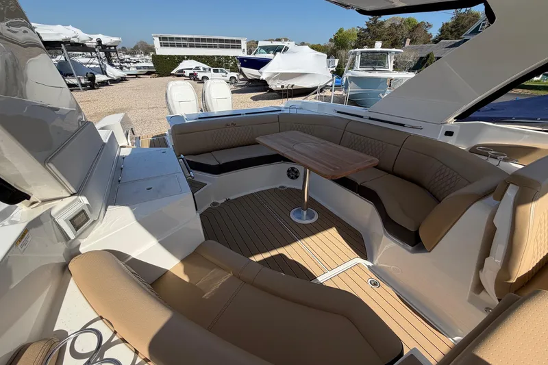 Slide: The Image of Luxurious interior of 2023 Sea Ray SLX 350 Outboard with elegant seating and wooden table. - 15