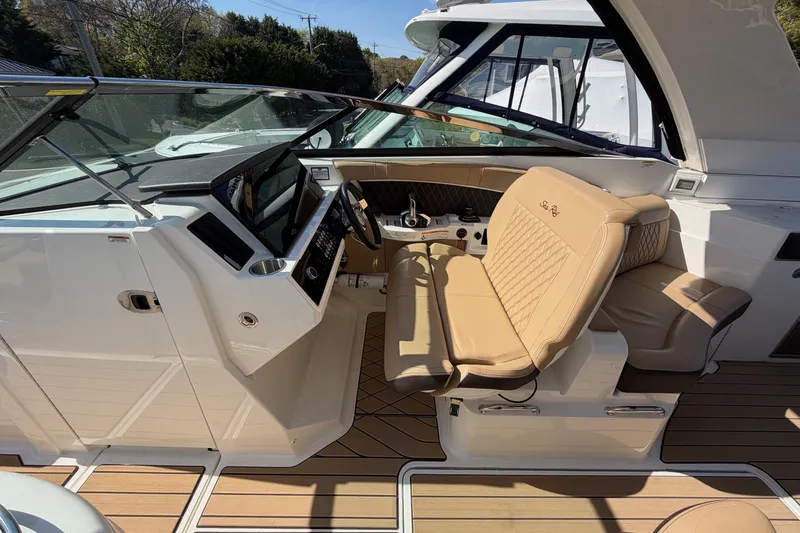 Slide: The Image of 2023 Sea Ray SLX 350 Outboard cockpit with luxurious seating and modern controls. - 16