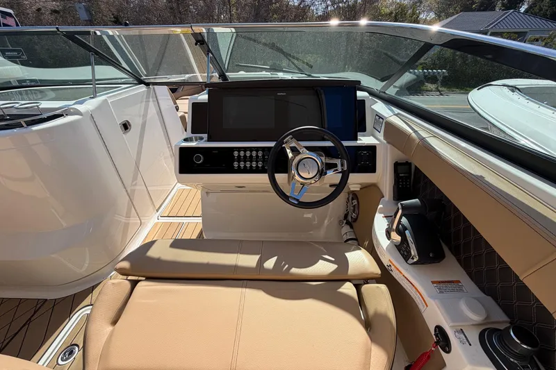 Slide: The Image of 2023 Sea Ray SLX 350 Outboard helm with modern controls and luxurious seating. - 18