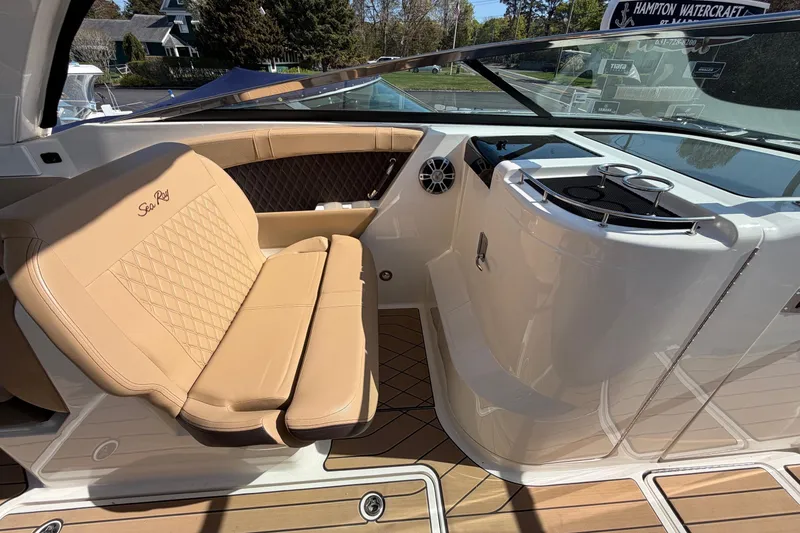 Slide: The Image of 2023 Sea Ray SLX 350 Outboard interior with tan seating and sleek design. - 19