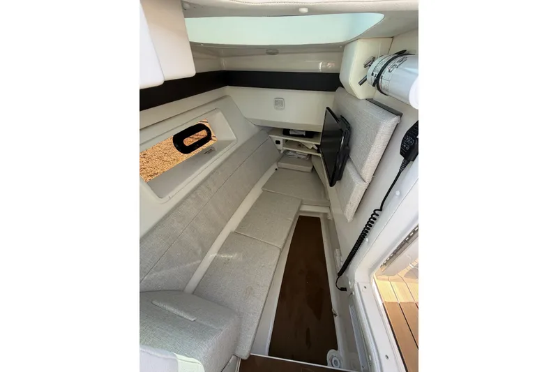 Slide: The Image of Interior cabin of 2023 Sea Ray SLX 350 Outboard, featuring modern seating and a window. - 20