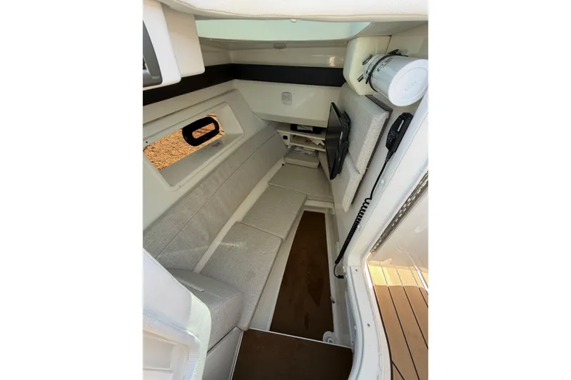 Slide: The Image of Interior cabin of 2023 Sea Ray SLX 350 Outboard, featuring seating and a small window. - 21
