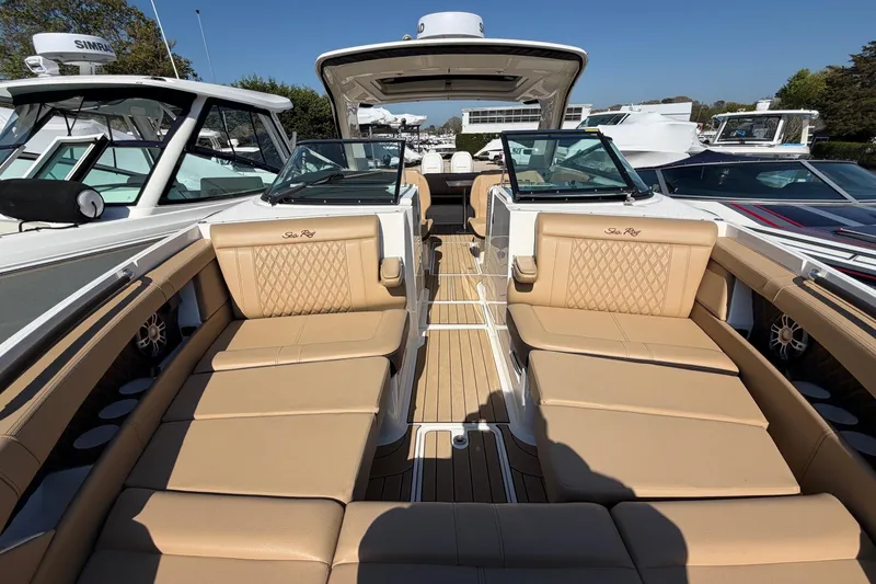Slide: The Image of 2023 Sea Ray SLX 350 Outboard luxury boat with tan seating and sleek design. - 22