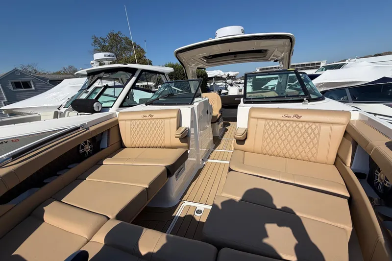 Slide: The Image of 2023 Sea Ray SLX 350 Outboard with luxurious tan seating and open deck layout. - 23