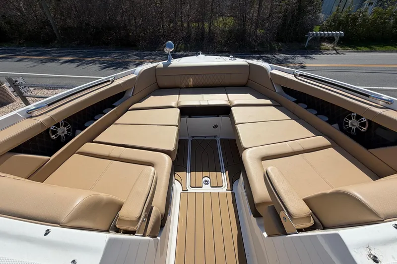 Slide: The Image of 2023 Sea Ray SLX 350 Outboard boat with spacious tan seating and sleek design. - 24