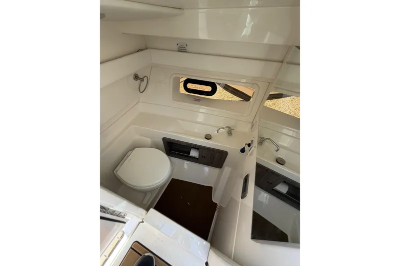 Slide: The Image of 2023 Sea Ray SLX 350 Outboard boat bathroom interior with sink and toilet. - 25