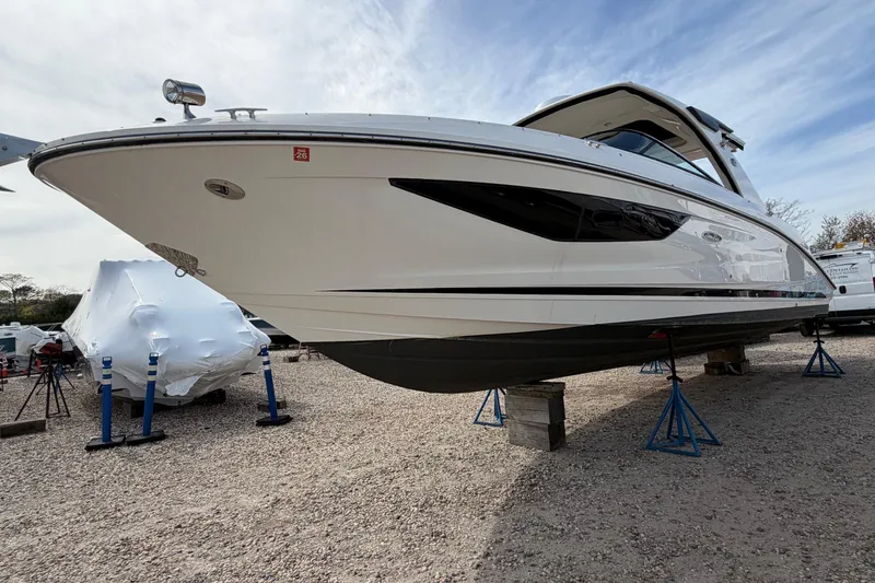Slide: The Image of 2023 Sea Ray SLX 350 Outboard boat on stands, displayed outdoors. - 29