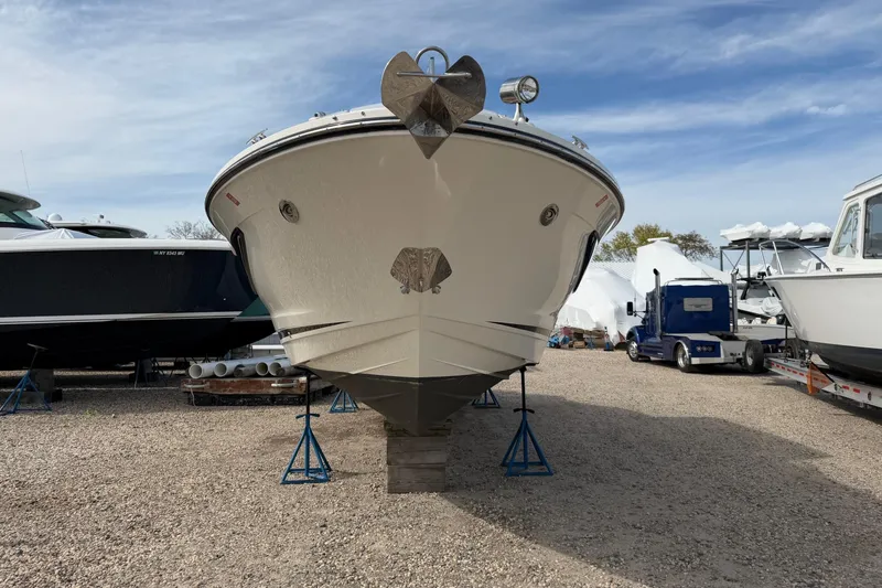 Slide: The Image of 2023 Sea Ray SLX 350 Outboard boat on stands in a marina. - 30