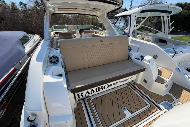 Slide: The Image of 2023 Sea Ray SLX 350 Outboard boat with luxurious seating and teak flooring. - 6