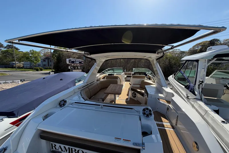 Slide: The Image of 2023 Sea Ray SLX 350 Outboard boat with spacious seating and canopy. - 9