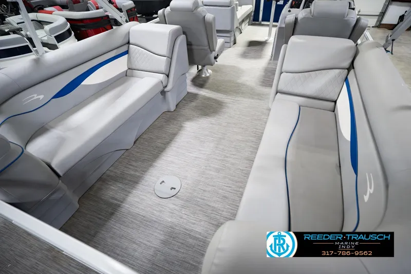 Slide: The Image of Interior of a 2021 Bennington 22 SVSR pontoon boat with gray seating and blue accents. - 16