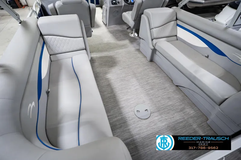 Slide: The Image of 2021 Bennington 22 SVSR pontoon boat interior with gray seating and blue accents. - 17